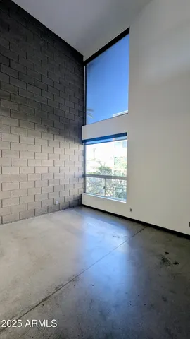 a view of an empty room with a fireplace and a window