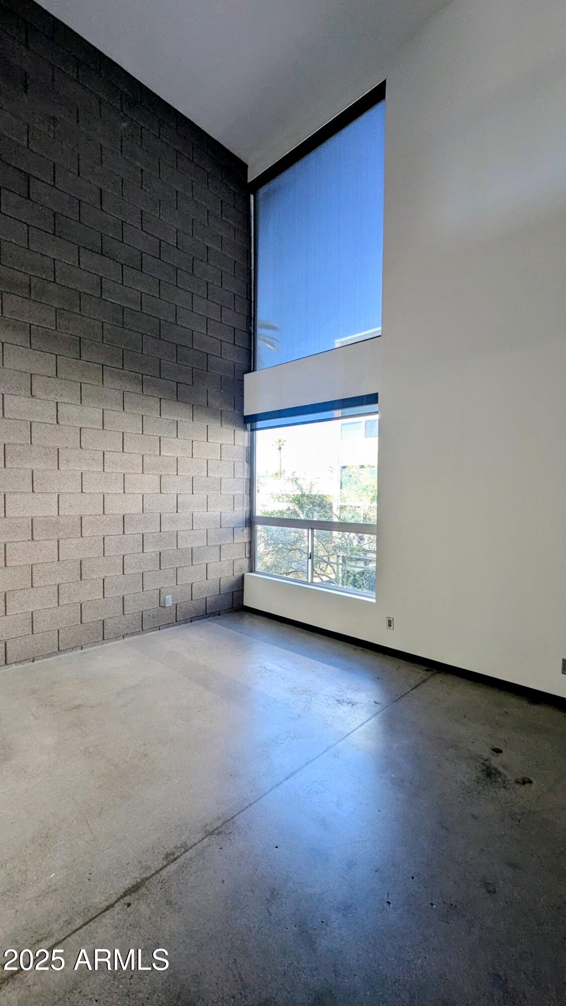 525 East Willetta Street, Unit 8 Phoenix, AZ 85004 - Photo 8 of 25 a view of an empty room with a fireplace and a window
