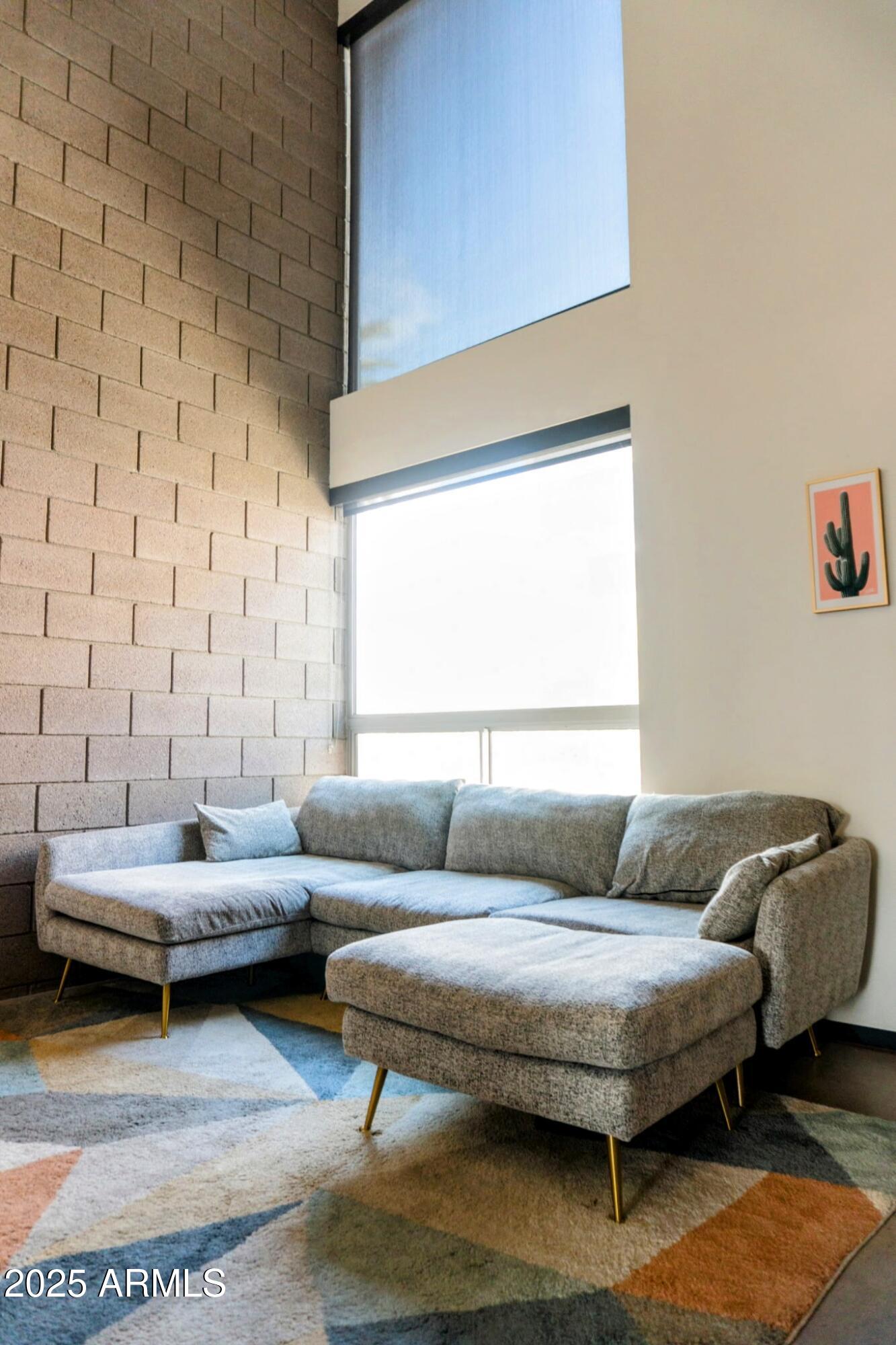 525 East Willetta Street, Unit 8 Phoenix, AZ 85004 - Photo 9 of 25 a living room with furniture and a window