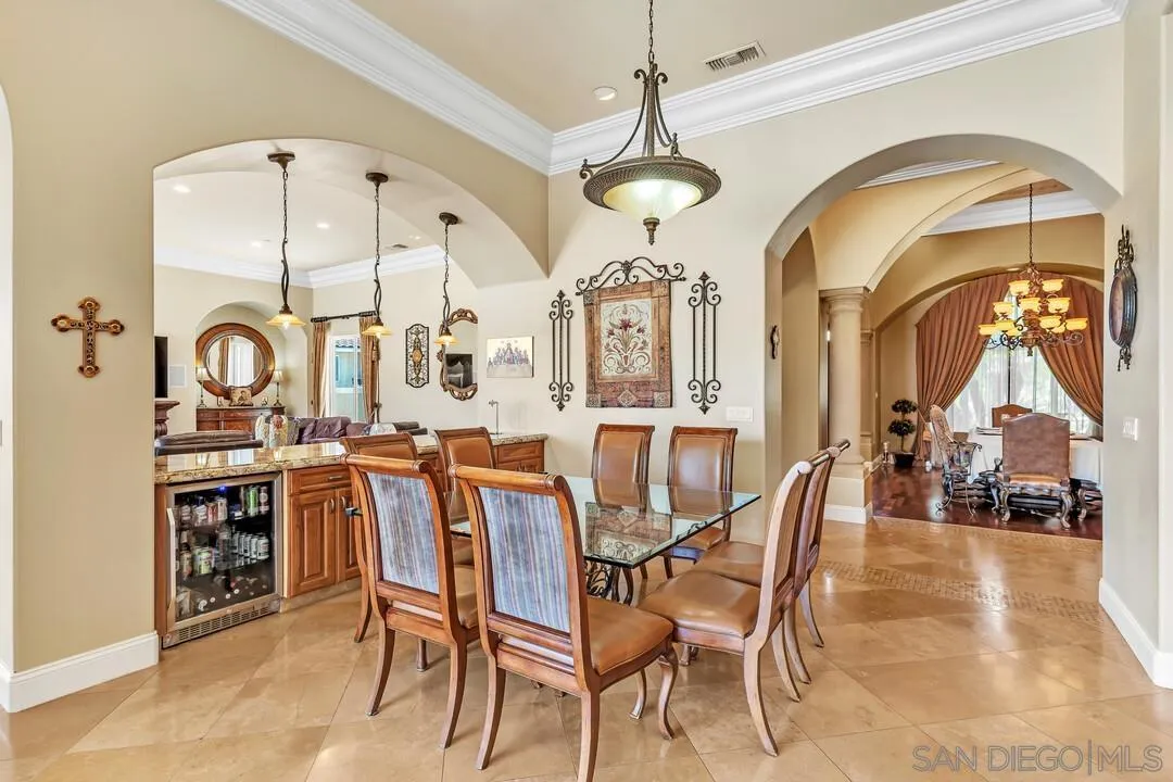 10321 Hitching Post Way Santee, CA 92071 - Photo 17 of 75 a dining room with furniture a chandelier and fireplace