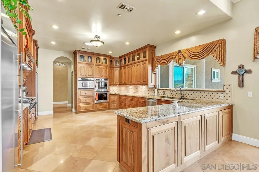 10321 Hitching Post Way Santee, CA 92071 - Photo 19 of 75 a bathroom with a granite countertop sink and a mirror