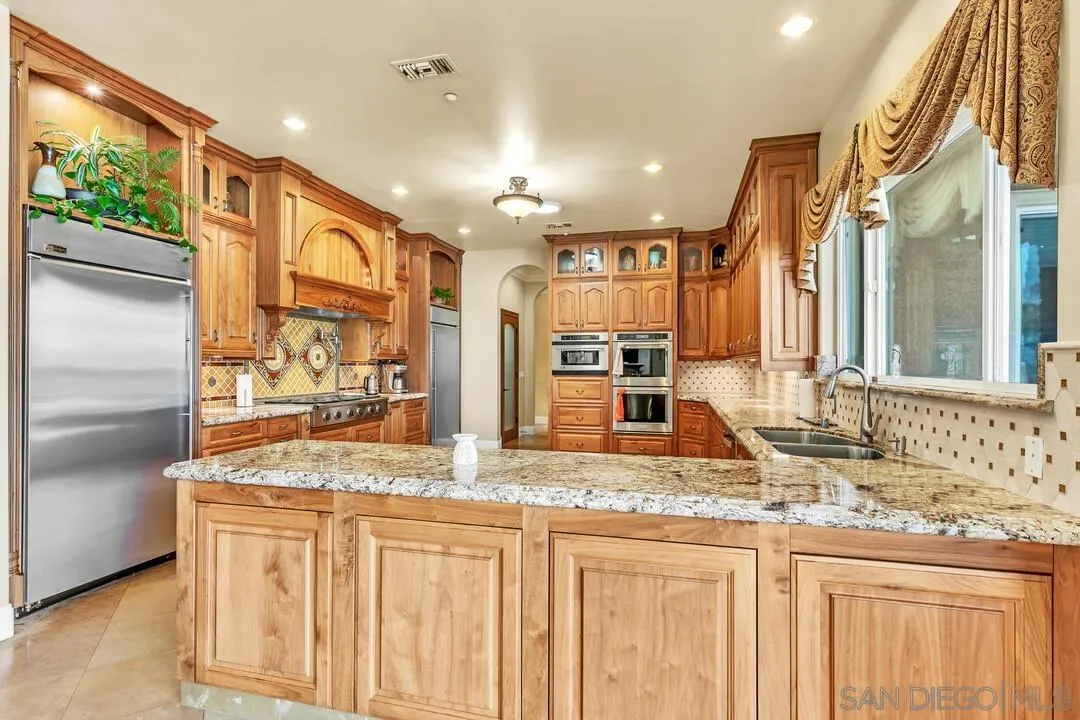 10321 Hitching Post Way Santee, CA 92071 - Photo 20 of 75 a bathroom with a granite countertop sink and a large mirror