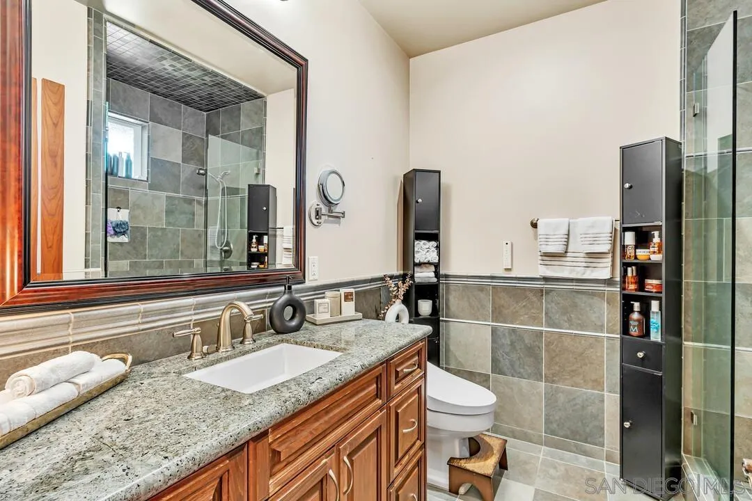 10321 Hitching Post Way Santee, CA 92071 - Photo 33 of 75 a bathroom with a granite countertop sink and a mirror