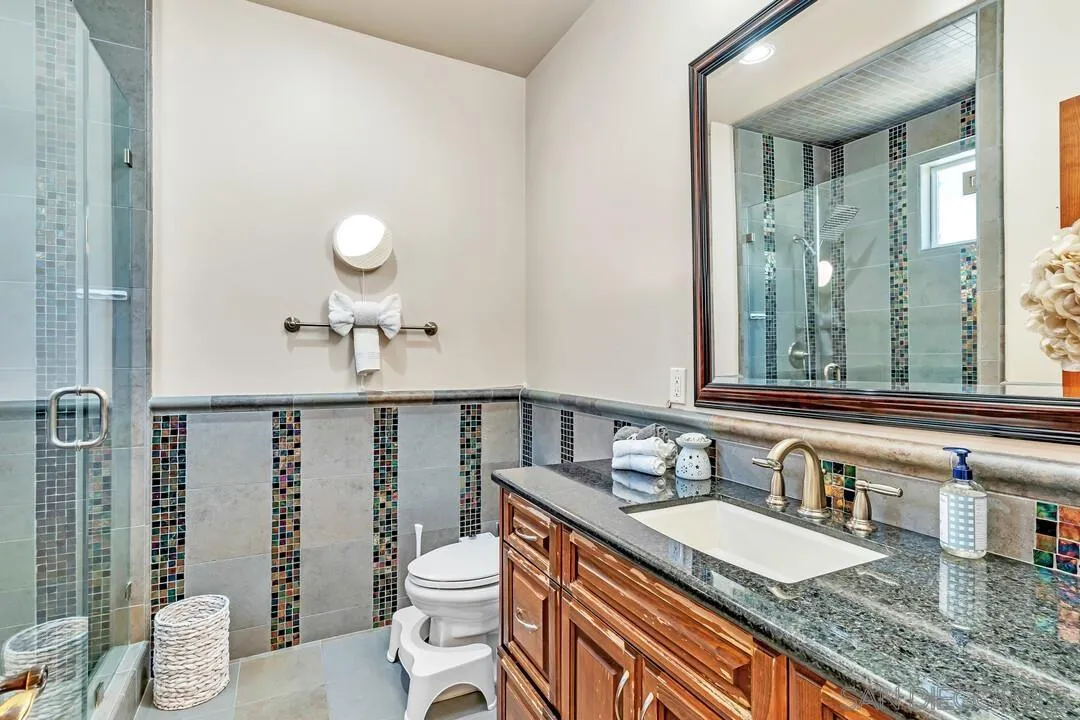 10321 Hitching Post Way Santee, CA 92071 - Photo 41 of 75 a bathroom with a granite countertop sink a toilet and a mirror