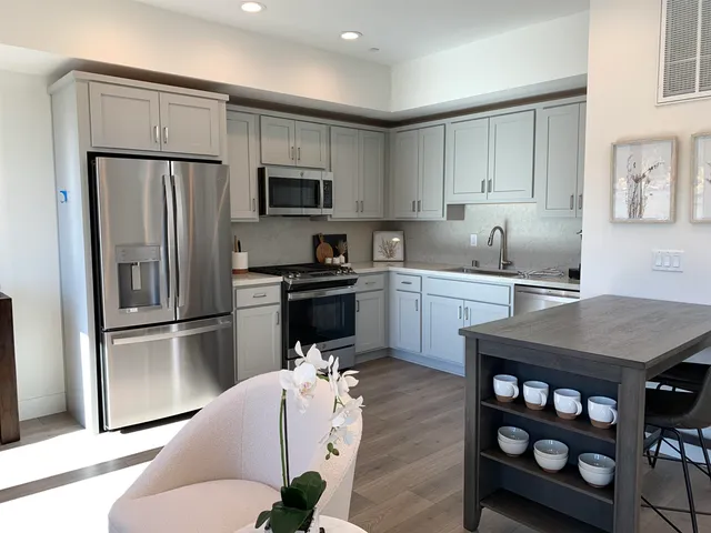 a kitchen with stainless steel appliances a refrigerator sink and cabinets