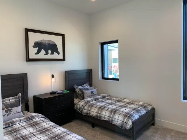 a bedroom with a bed dresser and a window