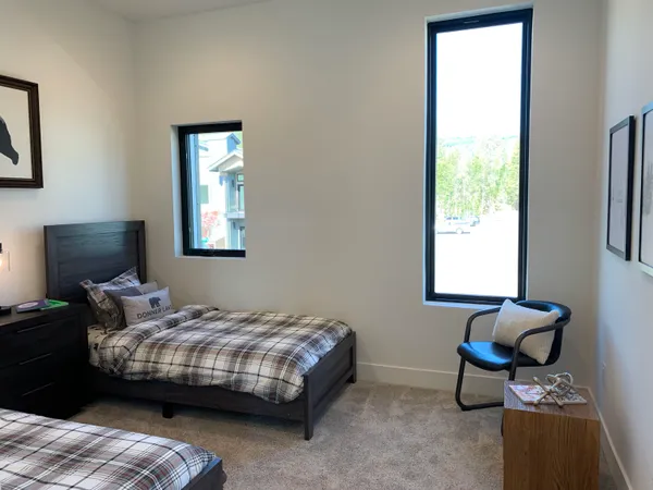 a bedroom with bed and a window