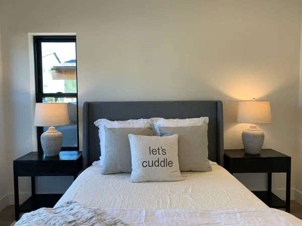 a large bed sitting in a bedroom next to a window