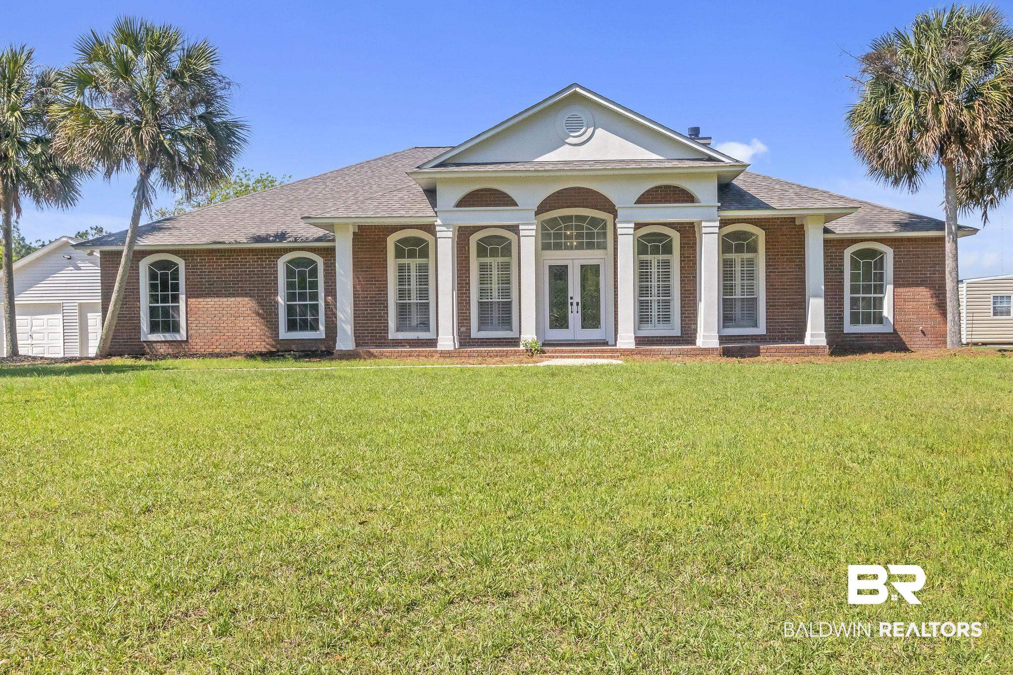 20265 Erin Pond Road Seminole, AL 36574 - Photo 92 of 97 Greek revival house with brick siding, a front yard, french doors, and roof with shingles