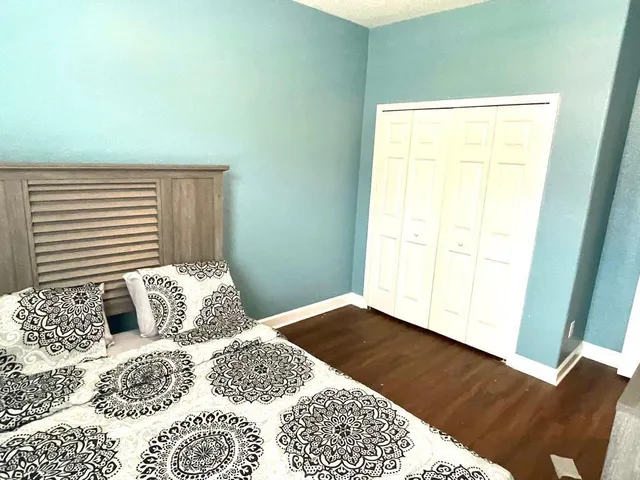 a bedroom with a bed and a window