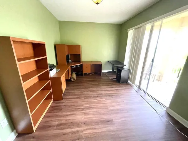 a view of a living room with furniture and wooden floor