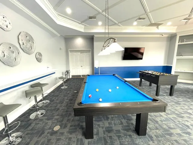 a room with furniture and pool table