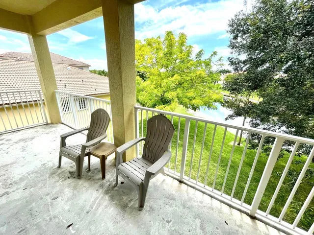 a view of a chair and tables in the balcony