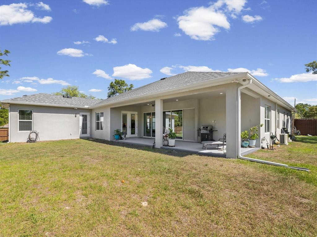 11981 Robina Road Weeki Wachee, FL 34614 - Photo 54 of 93 a view of a house with a backyard porch and sitting area