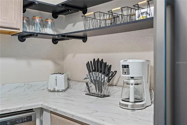 a kitchen with a sink and a stove top oven