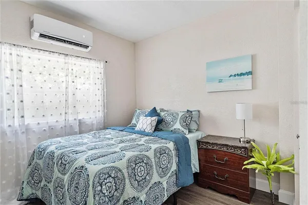 a bed sitting in a bedroom next to a blue wall