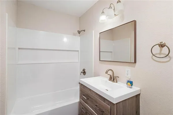 a room with a dresser and a window