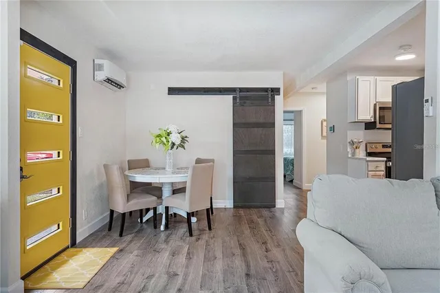 a view of a dining room with furniture and wooden floor