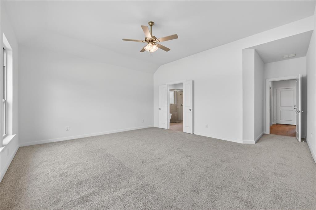 416 McAlpine Drive Springtown, TX 76082 - Photo 22 of 40 Spacious room featuring vaulted ceilings and light gray carpeting