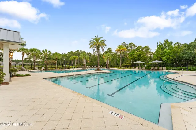 an aerial view of residential houses with outdoor space and swimming pool