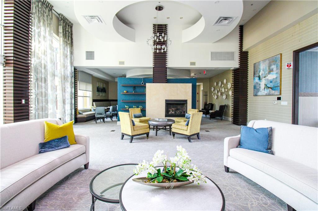 9123 Strada Place, Unit 7410 Naples, FL 34108 - Photo 15 of 50 Carpeted living room with a high ceiling
