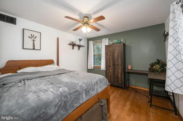 a bedroom with a bed dresser and a window