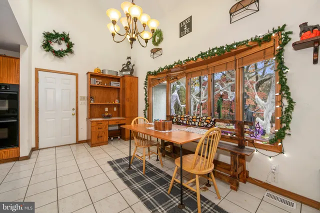 a view of a dining room with furniture and chandelier