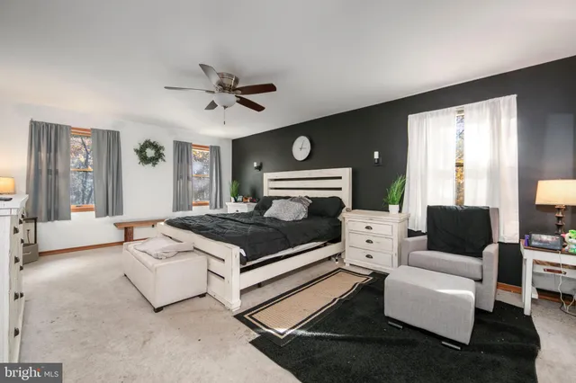 a living room with furniture and a ceiling fan