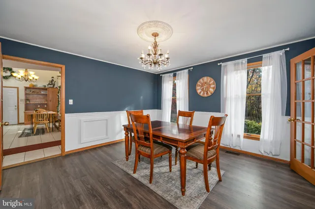 a view of a dining room with furniture wooden floor and chandelier