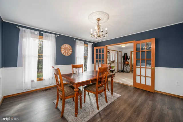 a view of a dining room with furniture wooden floor and chandelier