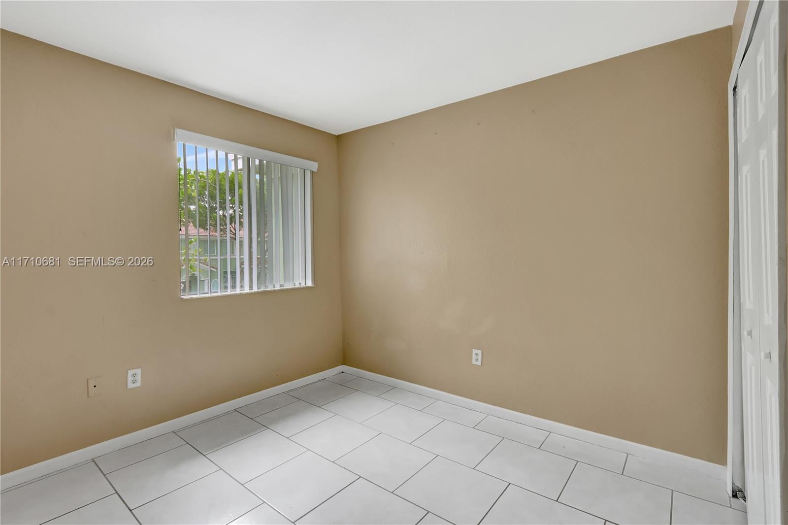 2874 Southeast 15th Road, Unit 52 Homestead, FL 33035 - Photo 11 of 16 a view of an empty room with windows