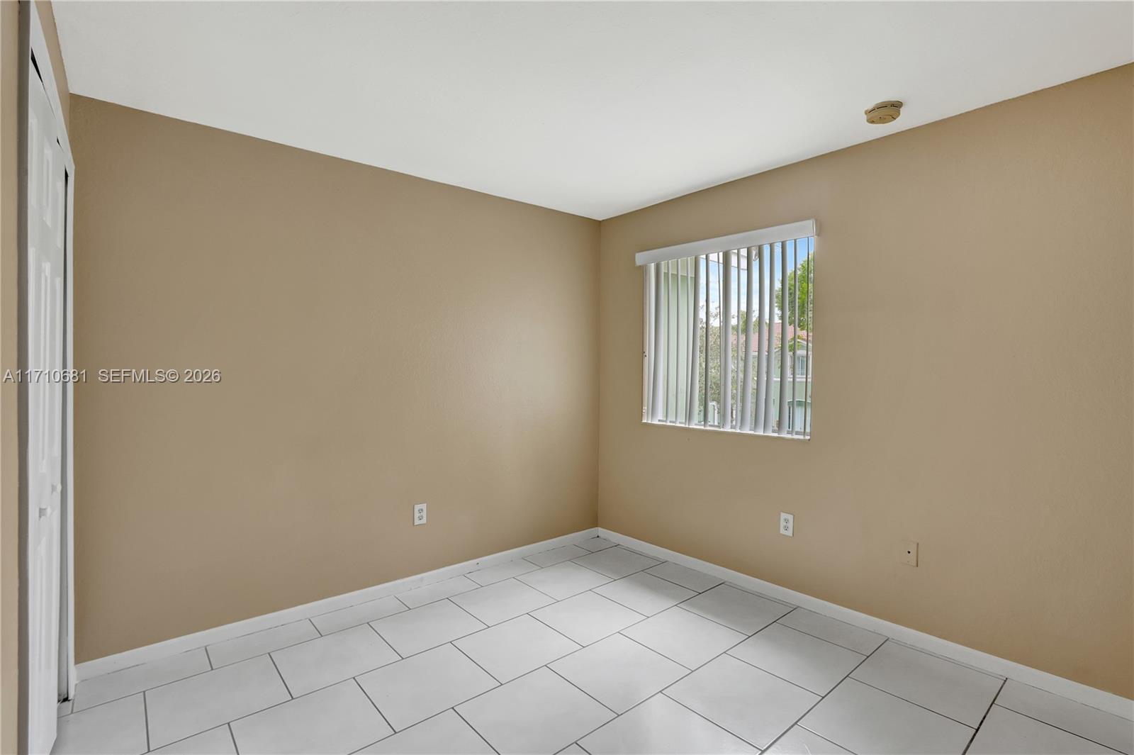 2874 Southeast 15th Road, Unit 52 Homestead, FL 33035 - Photo 12 of 16 a view of an empty room with windows