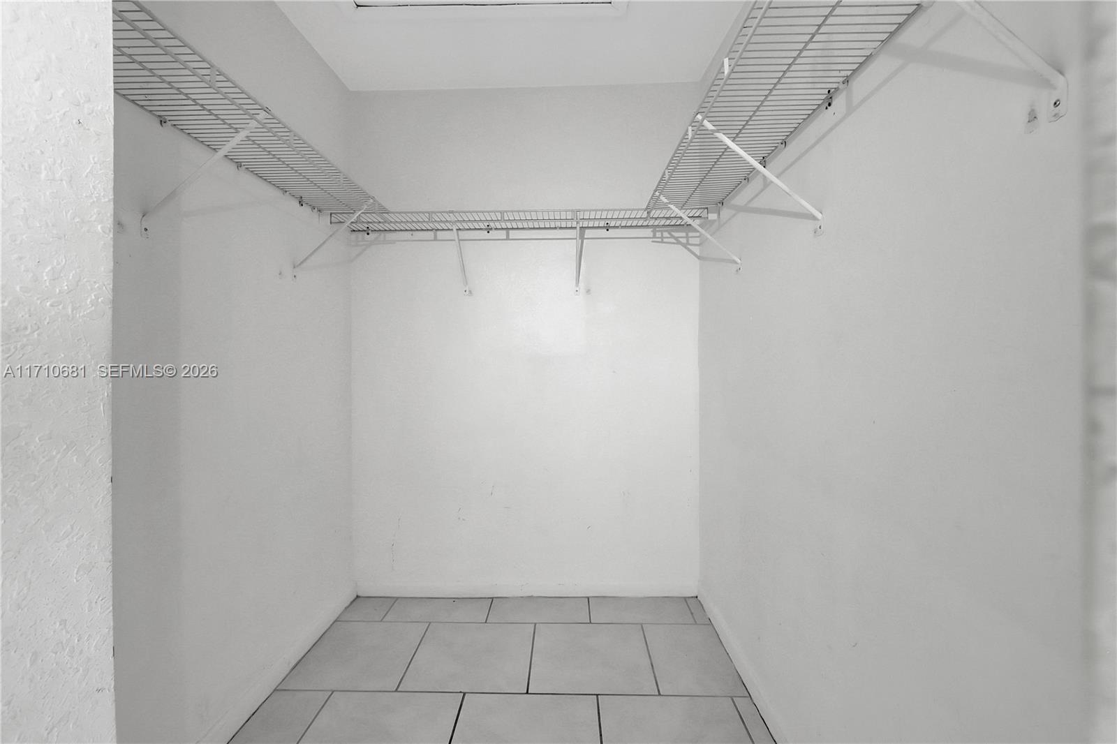 2874 Southeast 15th Road, Unit 52 Homestead, FL 33035 - Photo 16 of 16 a view of an empty walk in closet