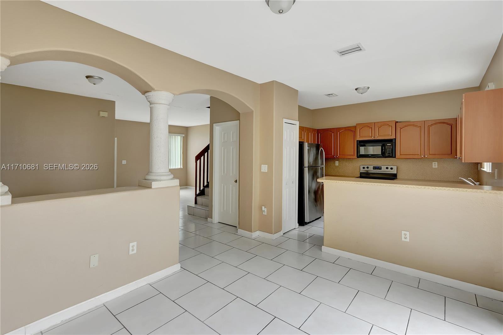 2874 Southeast 15th Road, Unit 52 Homestead, FL 33035 - Photo 6 of 16 a kitchen with cabinets and refrigerator