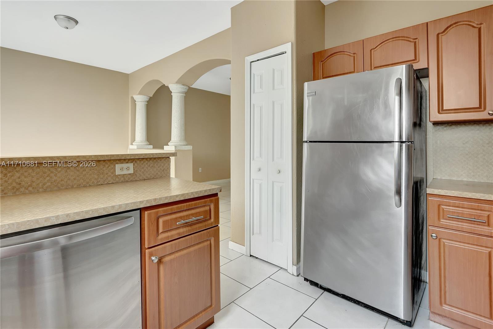 2874 Southeast 15th Road, Unit 52 Homestead, FL 33035 - Photo 8 of 16 a kitchen with stainless steel appliances a refrigerator and cabinets