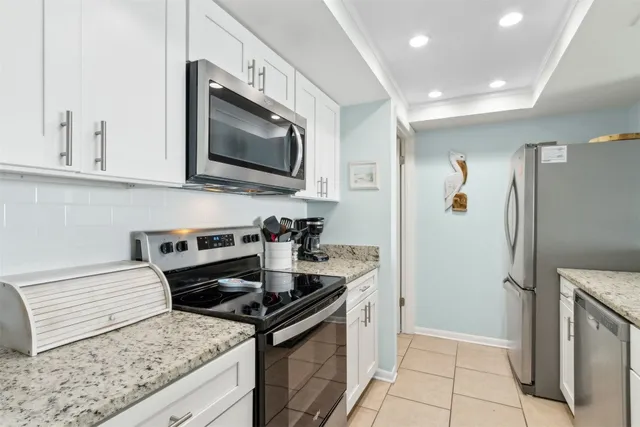 a kitchen with granite countertop a stove and a sink