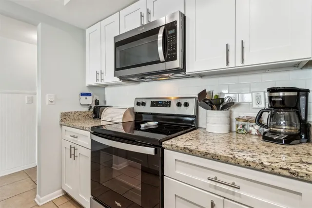 a kitchen with appliances a sink and cabinets