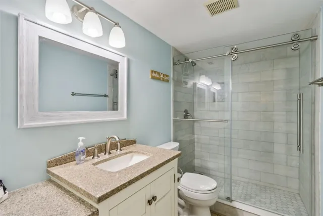 a bathroom with a sink toilet and shower