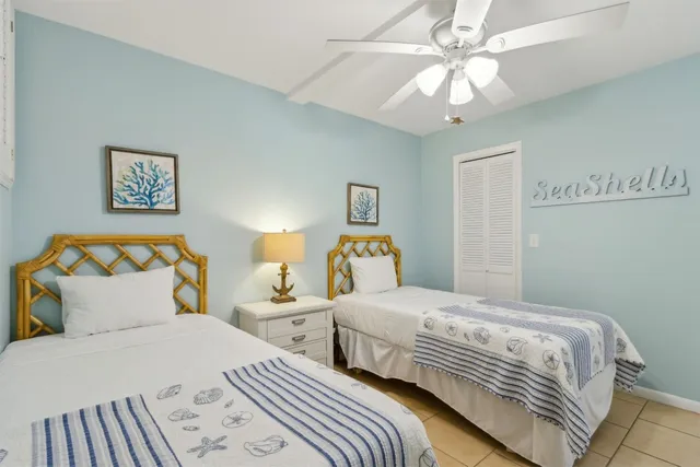 a bedroom with two beds and a chandelier