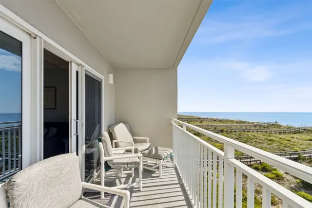 a view of a balcony with chairs