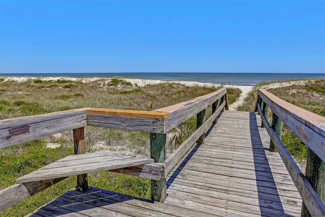 a view of balcony with wooden floor and ocean view