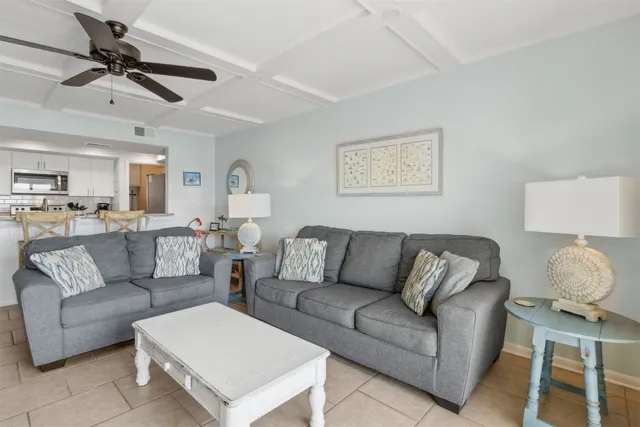 a living room with furniture and a ceiling fan