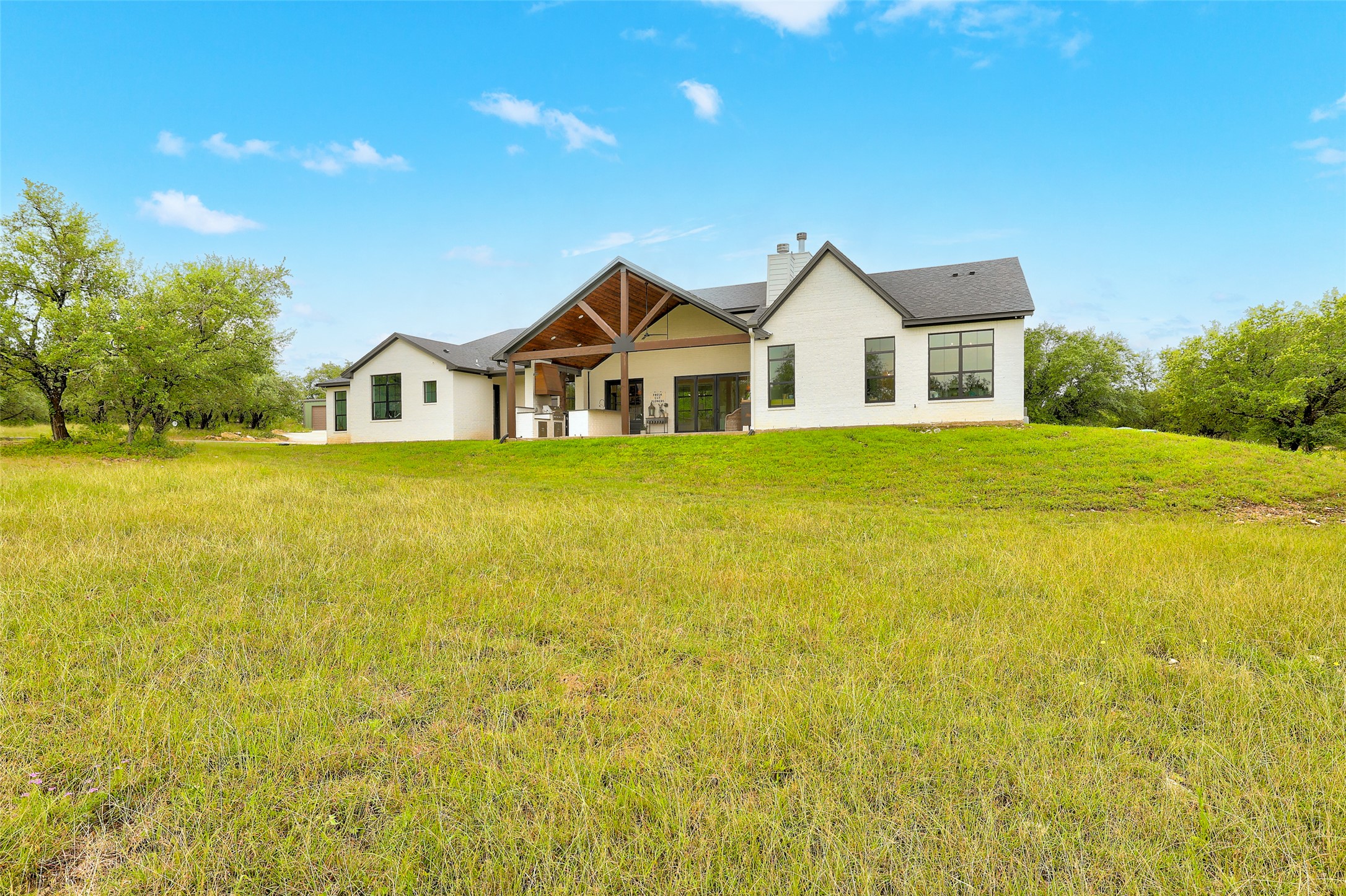 7670 Shiny Top Ranch Lane Salado, TX 76571 - Photo 38 of 40 a big house with a big yard and large trees