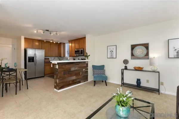 a kitchen with stainless steel appliances kitchen island granite countertop a refrigerator and a stove