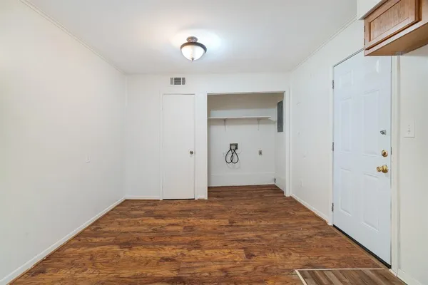 an empty room with a window and ceiling fan