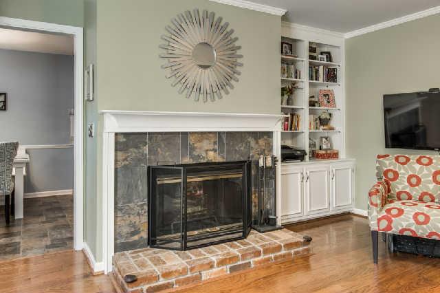 892 General George Patton Road, Unit 892 Nashville, TN 37221 - Photo 11 of 20 a living room with a fireplace cabinet and a flat screen tv