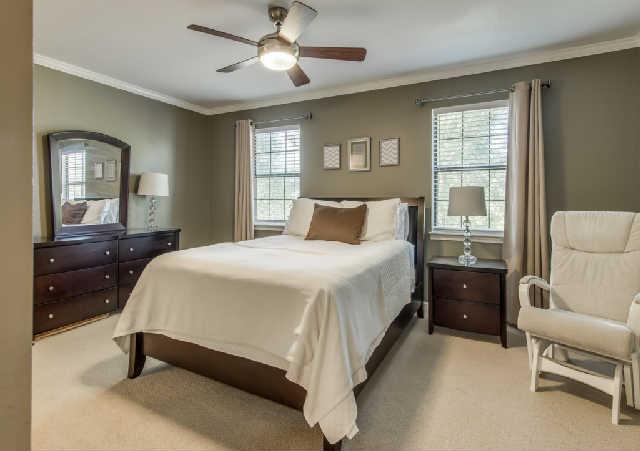 892 General George Patton Road, Unit 892 Nashville, TN 37221 - Photo 13 of 20 a bedroom with a large bed and a chandelier