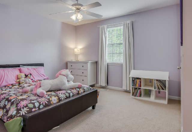 892 General George Patton Road, Unit 892 Nashville, TN 37221 - Photo 16 of 20 a bedroom with a large bed and a chandelier fan