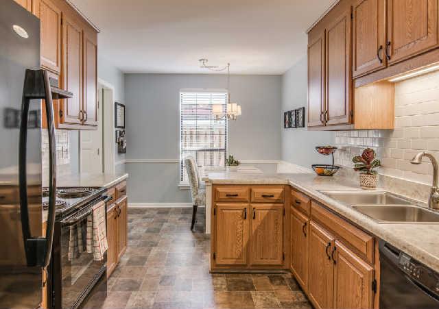 892 General George Patton Road, Unit 892 Nashville, TN 37221 - Photo 5 of 20 a kitchen with stainless steel appliances a sink stove and cabinets