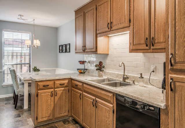 892 General George Patton Road, Unit 892 Nashville, TN 37221 - Photo 6 of 20 a kitchen with a sink stove and cabinets